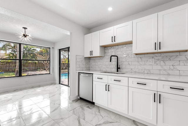 kitchen featuring sink, tasteful backsplash, stainless steel dishwasher, light stone countertops, and white cabinets