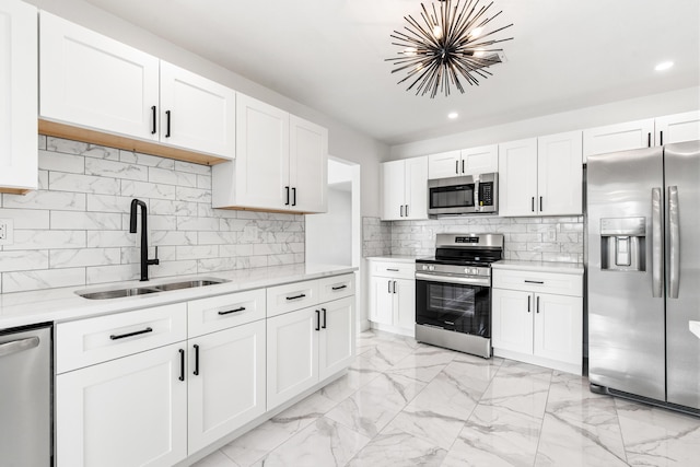 kitchen with sink, stainless steel appliances, light stone countertops, white cabinets, and decorative backsplash