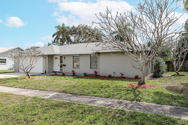 single story home with a garage and a front yard