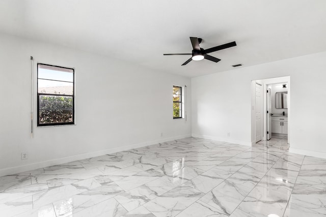 spare room with ceiling fan and a wealth of natural light