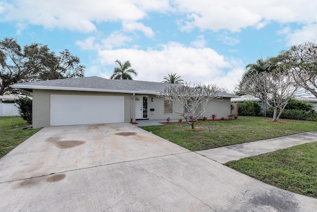 ranch-style house featuring a garage and a front yard