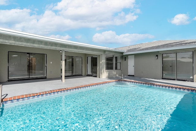 view of pool with ceiling fan and a patio area