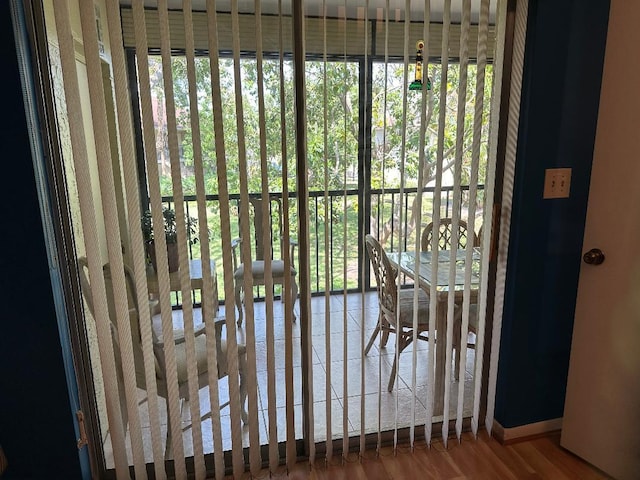 doorway to outside featuring wood-type flooring and a wealth of natural light