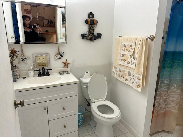 bathroom with vanity, tile patterned flooring, and toilet