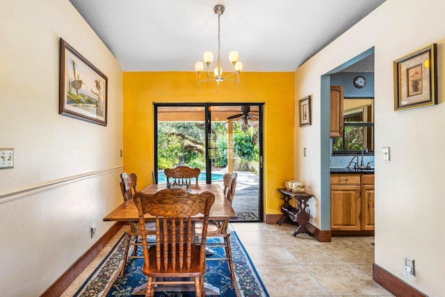 dining space featuring an inviting chandelier, sink, and light tile patterned floors