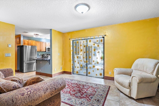 living room with light tile patterned flooring and a textured ceiling