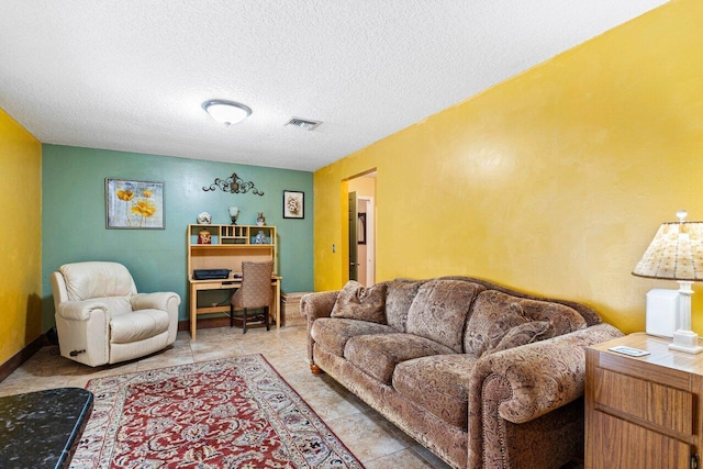 living room with light tile patterned floors and a textured ceiling