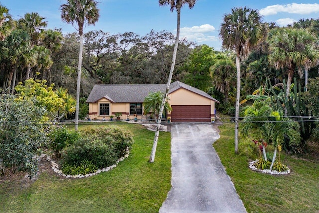 ranch-style house featuring a garage and a front yard