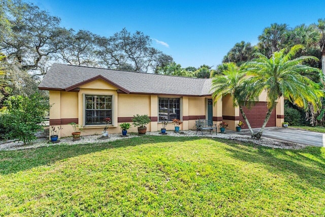 single story home with a garage and a front yard