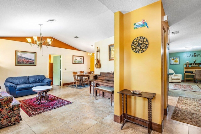 living room featuring light tile patterned floors, vaulted ceiling, a textured ceiling, and a notable chandelier