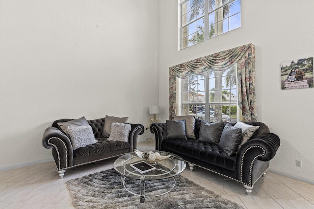 living room with a towering ceiling and a wealth of natural light