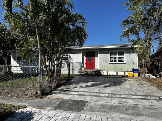 view of front of home featuring entry steps and fence