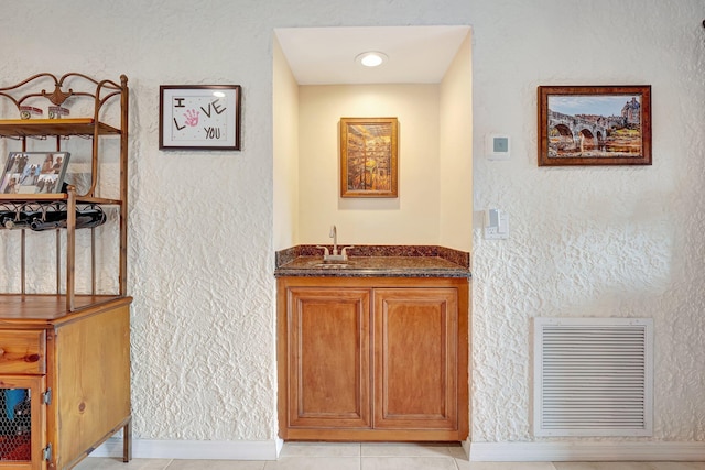 interior space featuring sink and light tile patterned flooring