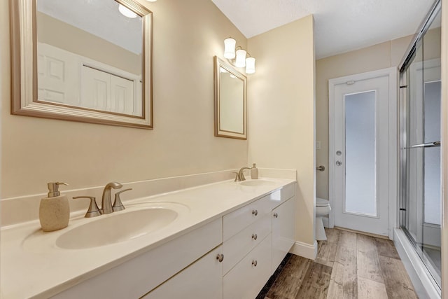 bathroom with vanity, hardwood / wood-style floors, toilet, and walk in shower