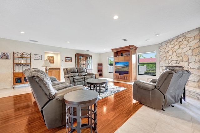 living room with plenty of natural light and light hardwood / wood-style flooring