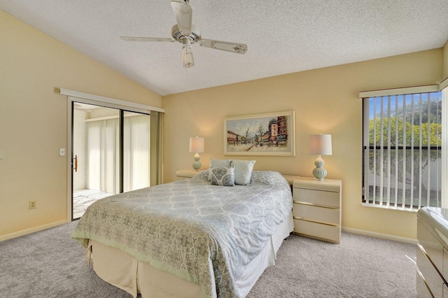 bedroom featuring lofted ceiling, light colored carpet, ceiling fan, a textured ceiling, and a closet