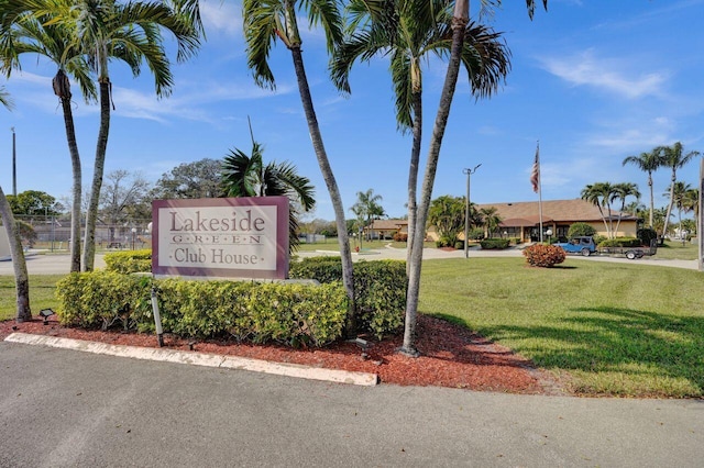 community sign featuring a lawn