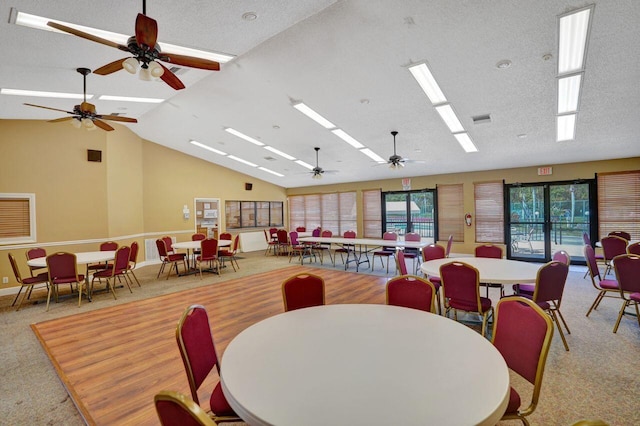 dining space featuring high vaulted ceiling, light carpet, a textured ceiling, and a skylight