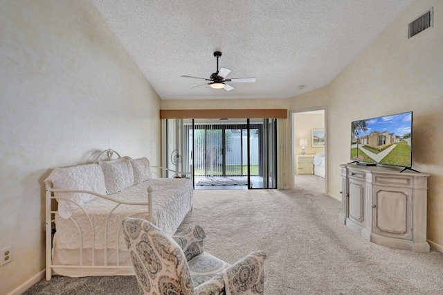 carpeted living room with ceiling fan, vaulted ceiling, and a textured ceiling