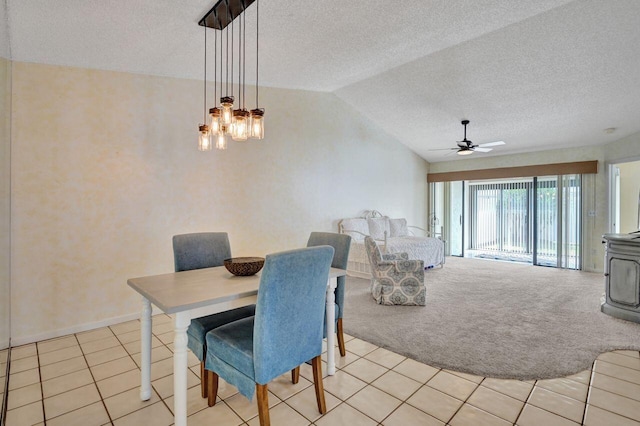 dining area featuring light colored carpet, lofted ceiling, a textured ceiling, and a wood stove