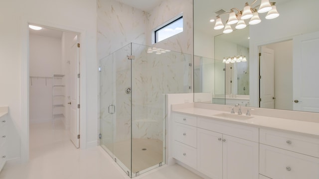 bathroom with vanity and a shower with shower door