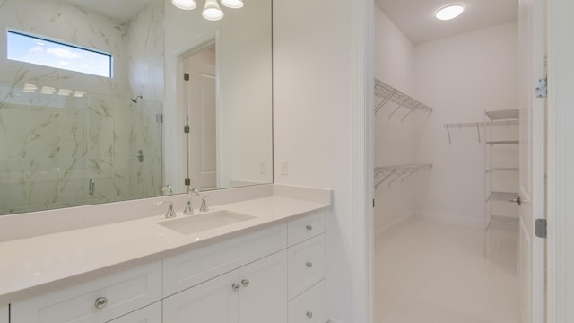 bathroom with a shower with door and vanity