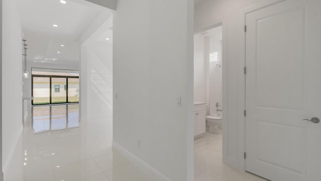 hall featuring light tile patterned flooring