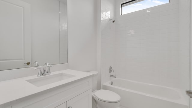 full bathroom with tiled shower / bath, vanity, and toilet