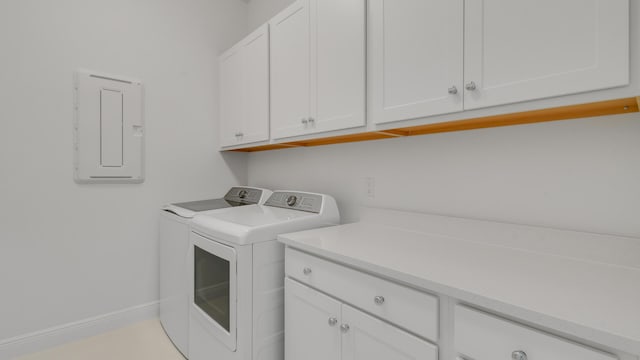 laundry room featuring cabinets, electric panel, and independent washer and dryer