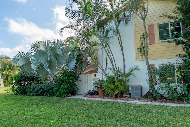 exterior space featuring a yard and cooling unit