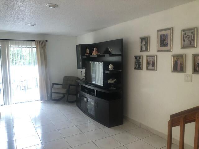 tiled living room with a textured ceiling