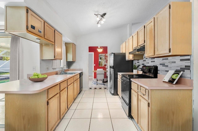 kitchen featuring sink, black appliances, light tile patterned flooring, decorative backsplash, and vaulted ceiling