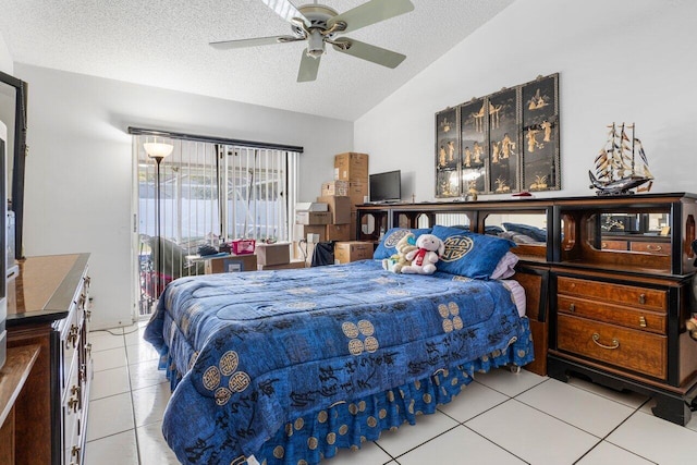 bedroom with ceiling fan, lofted ceiling, a textured ceiling, and light tile patterned floors