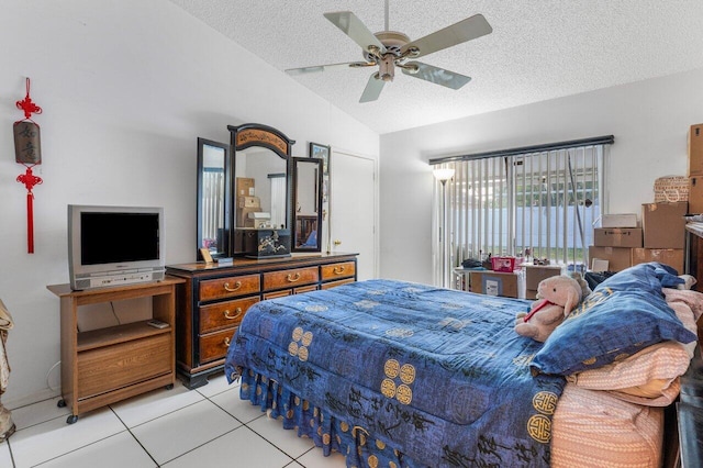 tiled bedroom featuring lofted ceiling, ceiling fan, and a textured ceiling