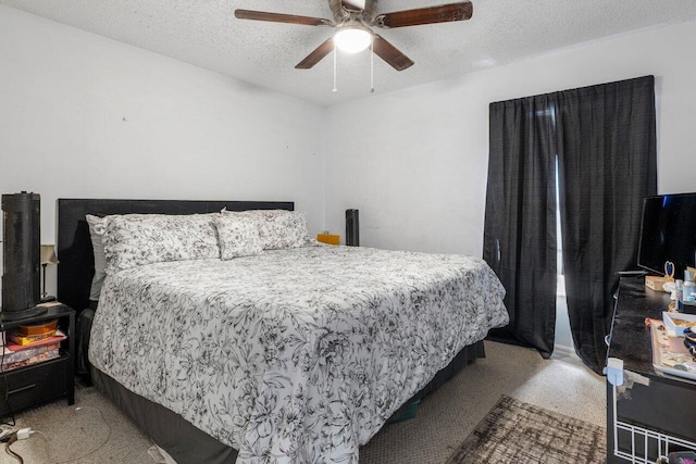 carpeted bedroom with ceiling fan and a textured ceiling