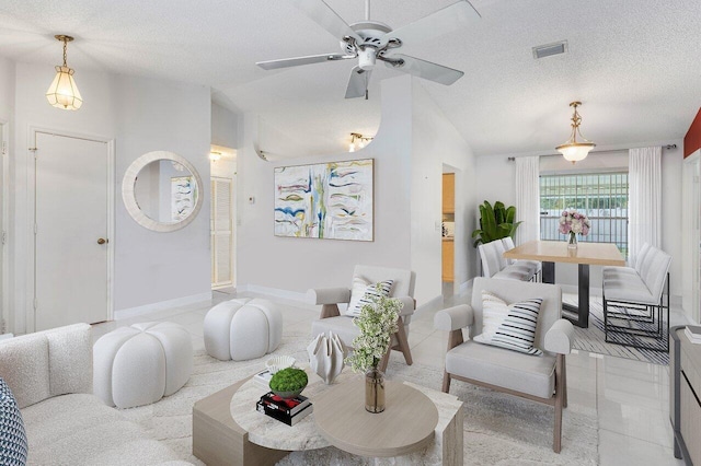 living room featuring lofted ceiling, light tile patterned floors, and a textured ceiling