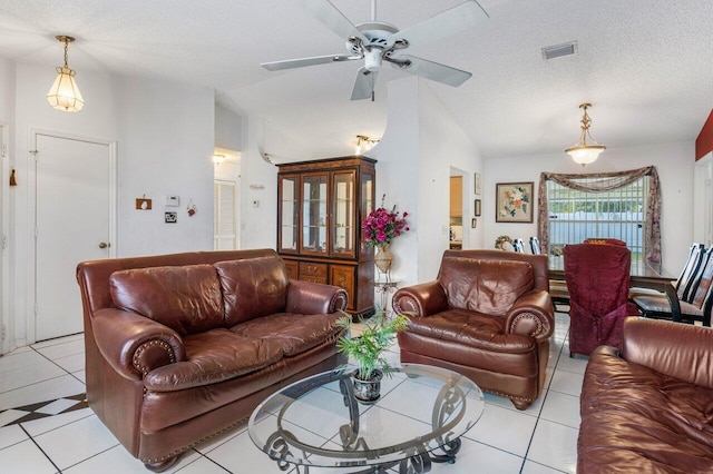 tiled living room featuring ceiling fan, vaulted ceiling, and a textured ceiling