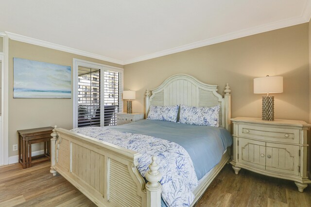 bedroom with hardwood / wood-style floors and crown molding