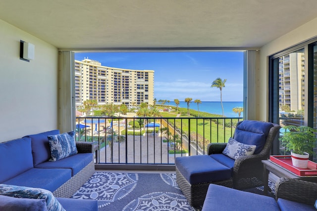 balcony featuring an outdoor hangout area and a water view