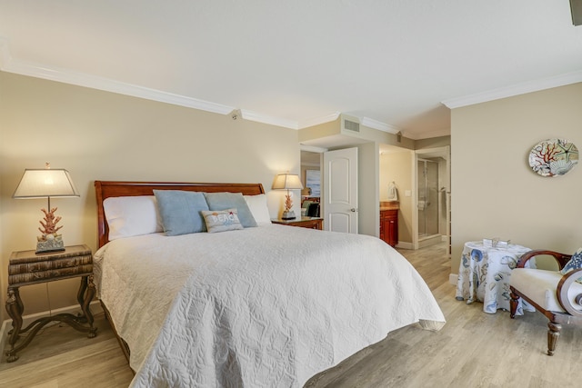 bedroom with ornamental molding, light hardwood / wood-style floors, and ensuite bath