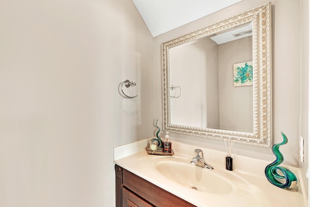 bathroom with vanity and vaulted ceiling