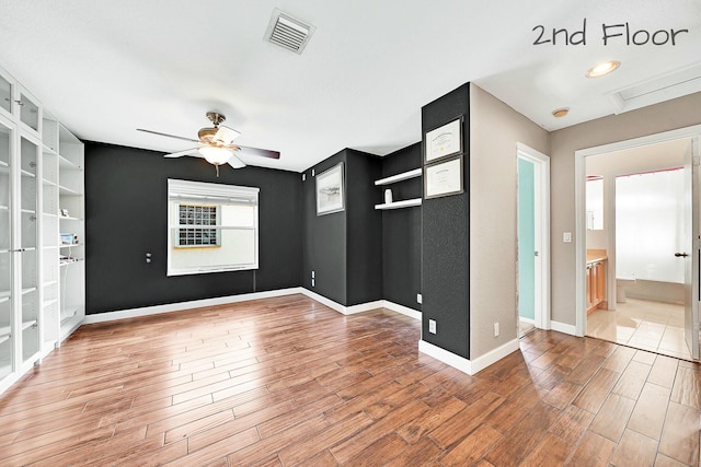 spare room with hardwood / wood-style flooring and ceiling fan