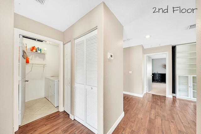 hall featuring washing machine and dryer and hardwood / wood-style floors