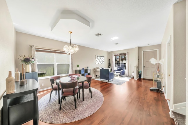 dining room featuring dark hardwood / wood-style floors and a chandelier