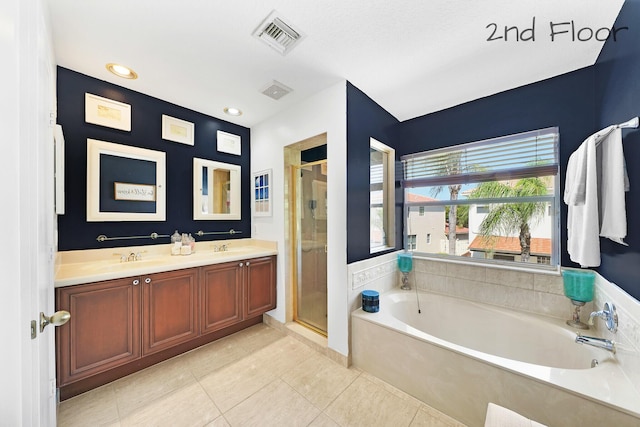 bathroom with vanity, plus walk in shower, and tile patterned flooring