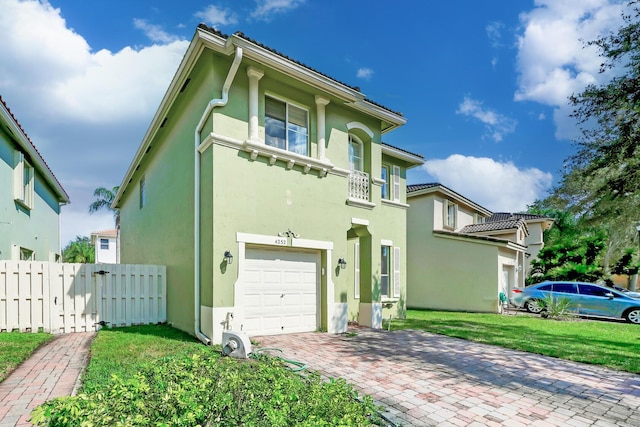 mediterranean / spanish-style home with a garage and a front lawn