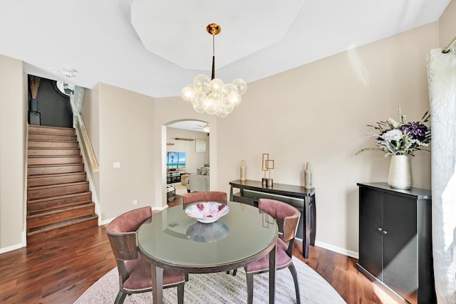 dining room featuring a notable chandelier and dark hardwood / wood-style floors