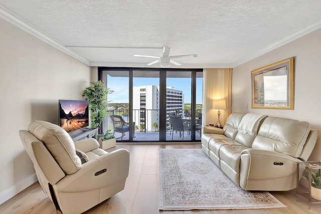 living room with floor to ceiling windows, a textured ceiling, light hardwood / wood-style flooring, ornamental molding, and ceiling fan