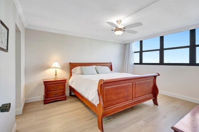 bedroom featuring crown molding, ceiling fan, and light hardwood / wood-style floors