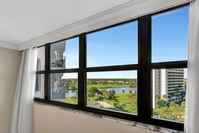 interior details with a water view and crown molding